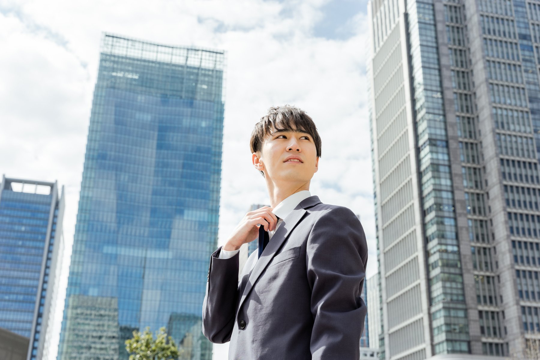 A male business man in a 20 -year -old suit who works in the outside where the suit is hot in the hot summer